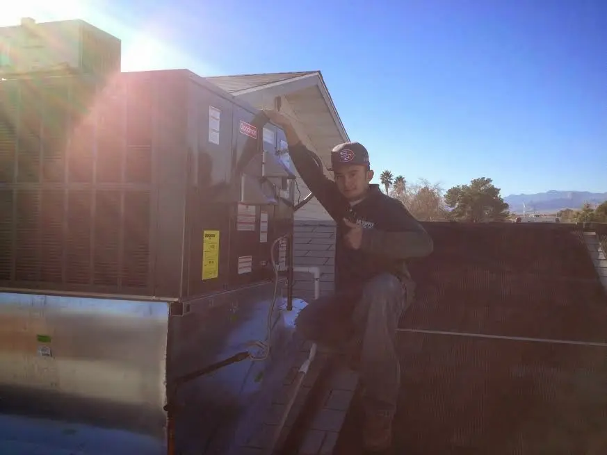 HVAC technician performing AC Tune-Up on a rooftop unit in Sunnyvale
